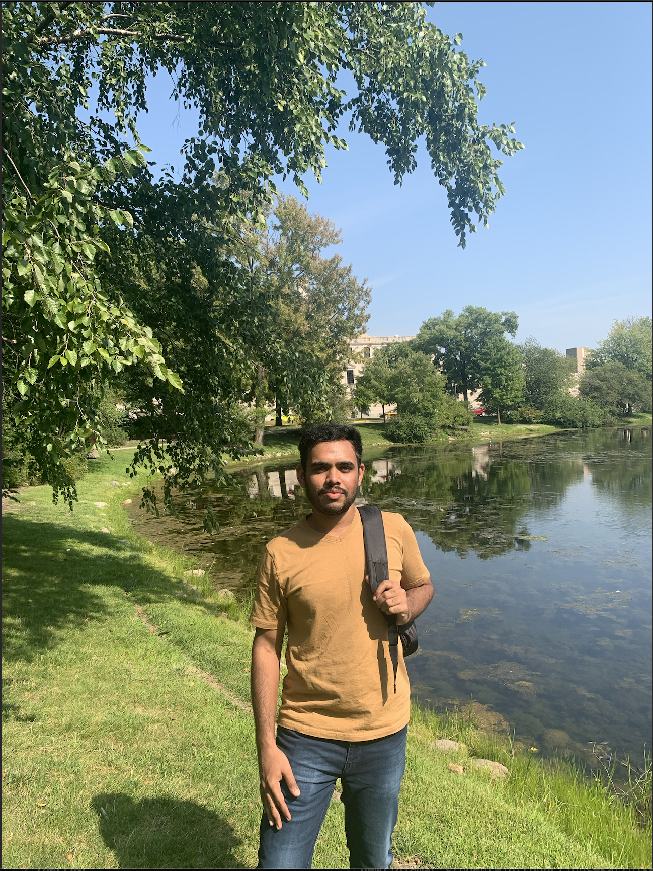 A guy standing in front of lake